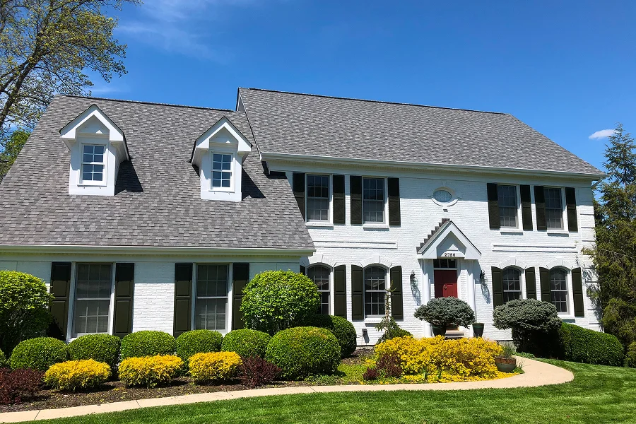 Exterior painting of a white two story home with black shutters in Milford Ohio by Swanson's Painting house painters