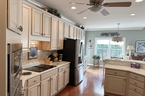 Cream kitchen cabinet painting with light quartz counters in Milford Ohio by Swanson's Painting house painters