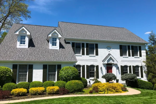 Exterior painting of a white two story home with black shutters in Milford Ohio by Swanson's Painting house painters