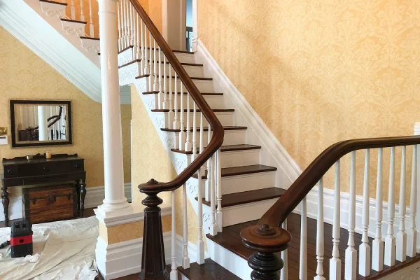 Interior painting of a walnut and white staircase in Milford Ohio by Swanson's Painting house painters